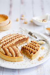 Delicious mini tarts with nuts and custard. Assortment of delicious and colorful dessert, salted caramel tart, lemon curd tart, cherry cream chocolate tart made by pastry chef.