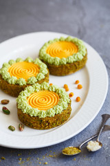 Delicious mini tarts with nuts and custard. Assortment of delicious and colorful dessert, salted caramel tart, lemon curd tart, cherry cream chocolate tart made by pastry chef.