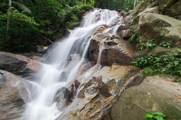 Naklejka na ściany i meble Waterfall/stream in a deep rain forest.