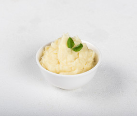 Mashed potatoes with greens on a light background in rustic style