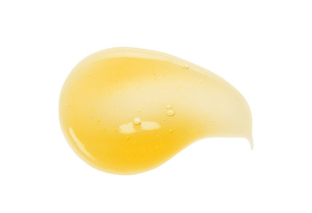 Vitamin C orange gel serum texture. Exfoliating cleanser swatch smear smudge isolated on white background. Cosmetic  beauty product sample with bubbles close up
