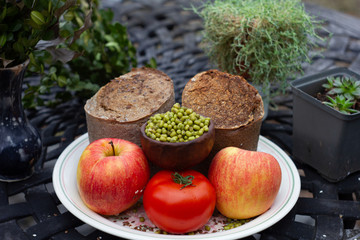 Buckwheat bread with tomatoes and peas on white plate background