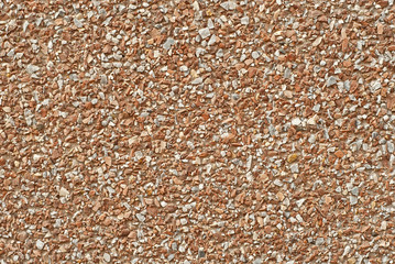 The texture of the wall is made of small orange and white stones.