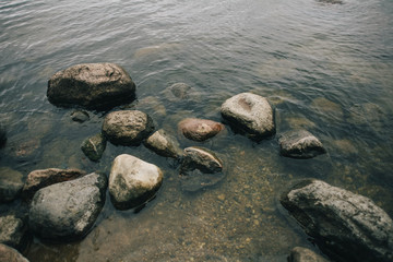 Stepping stones over river and small waterfall.