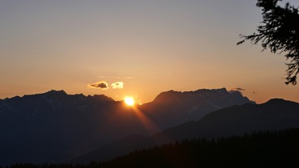 orange sky in the morning over the austrian alps