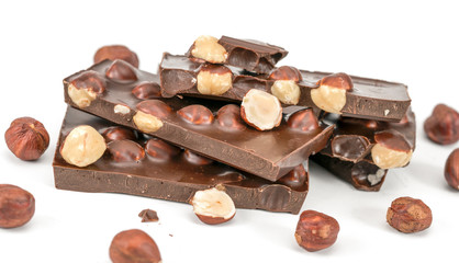 black chocolate with hazelnuts on a white background