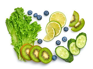 Naklejka na ściany i meble Fresh fruits healthy diet concept. Raw mixed vegan juicy food background, green salad, cucumber, kiwi isolated on white. Variety of fresh green veg fruit for juice or smoothie. Detox clean eating