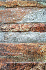 A background of colorful stone wall close up view