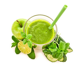 Freshly blended green fruit smoothie in glass, healthy detox vitamin vegan food concept. Raw fresh vitamins smoothie drink with basil, apple, cucumber isolated on white, top view
