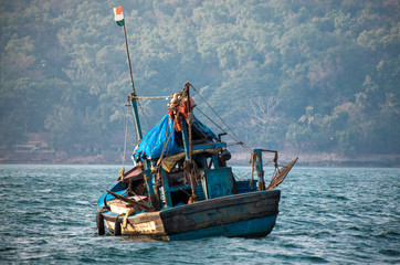 Obraz premium Stara indyjska łódź rybacka. Statek pływa po morzu w poszukiwaniu ryb.
