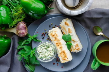 Healthy breakfast: pancakes with cottage cheese and dill lie on a round plate