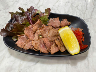 Tongue of a cow or Beef tongue grilled.