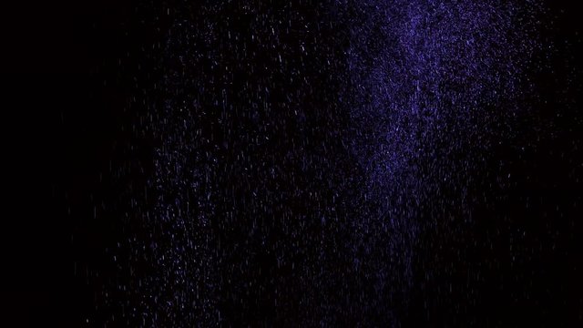 Perfume cloud on black background in slow motion