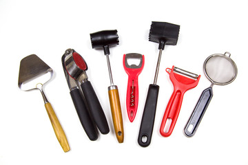 Kitchen appliances corkscrew peeler cheese cutter the garlic press strainer isolated on a white background. Kitchen utensils, items.