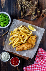Fish and chips on a wooden background. British fast food. Recipes. Snack to beer. English cuisine.
