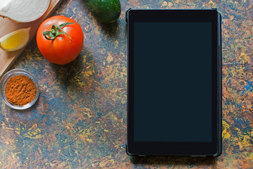 fresh vegetables on wooden board and tablet