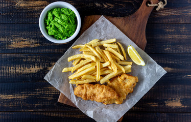 Fish and chips on a wooden background. British fast food. Recipes. Snack to beer. English cuisine.