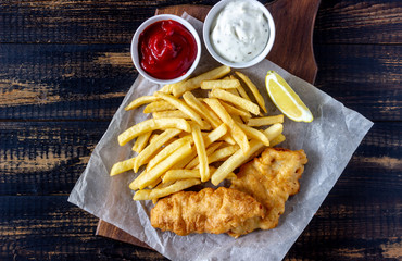 Fish and chips on a wooden background. British fast food. Recipes. Snack to beer. English cuisine.