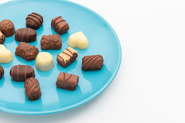Gourmet chocolates on blue plate