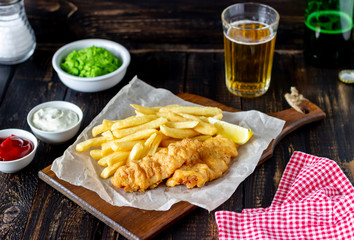 Fish and chips on a wooden background. British fast food. Recipes. Snack to beer. English cuisine.