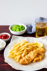 Fish and chips on a wooden background. British fast food. Recipes. Snack to beer. English cuisine.