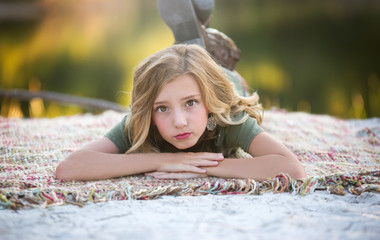Beautiful Young Girl On Blanket By Lake