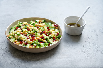 Quinoa salad with chickpeas, cucumber, avocado, parsley and pomegranate seeds