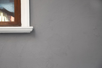 An blank gray wall with windows