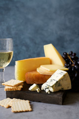Cheese platter with cheese assortment and grapes. Party or gathering eating concept