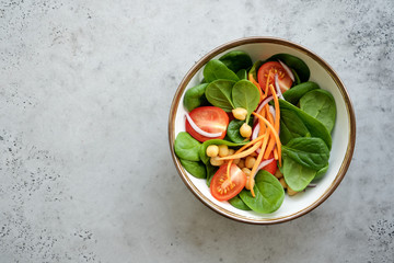Spinach salad with tomatoes, carrots and chickpeas. Detox, healthy eating concept