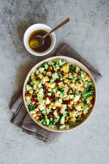 Quinoa salad with chickpeas, cucumber, avocado, parsley and pomegranate seeds