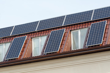 Fototapeta premium Solar panels for green energy on the tiled roof of house, Photovoltaic module and regenerative energy system.