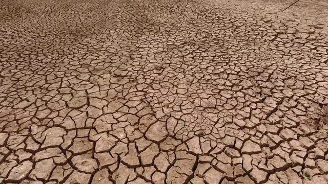 A dry lake bed with the natural surface of broken clay, deadly fields, concepts ecology, natural disasters