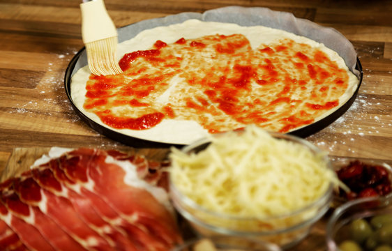 Preparing pizza in the kitchen.