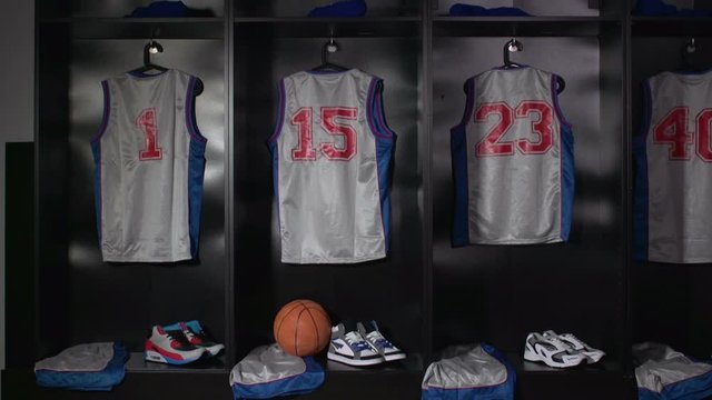 Basketball Changing room / Locker room. All the kit or uniform is laid out ready for the players. Camera dolly motion.