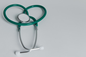 green stethoscope on the white background