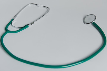 green stethoscope on the white background