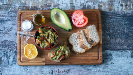 Fototapeta na wymiar Fresh guacamole, bread on a wooden board. Keto diet.
