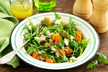 salad with pumpkin, feta and arugula. . Selective focus