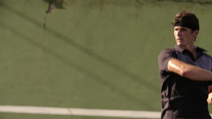 Professional tennis player hitting forehands strokes on hard court. Fit young man in sportswear playing tennis on hard court on a sunny day. - Powered by Adobe