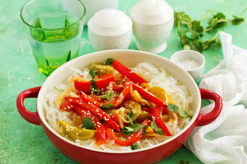 Baked bell peppers with rice noodles in Asian style.