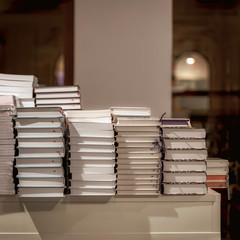 Stacks of books on table, modern urban bookshop, library. Education, school, study concept