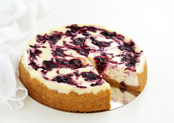 Homemade cheesecake with black currant jelly.