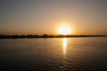 Naklejka premium Sunset viewed from across a river