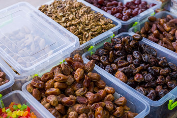 store counter with dried fruits. In plastic containers, the fruits of dried dates. Healthy food. natural nutrition. Vegetarian Products