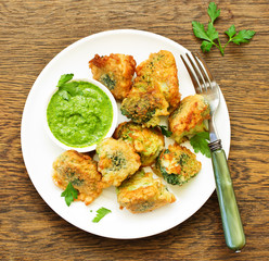 Fried broccoli in batter with green sauce. Selective focus