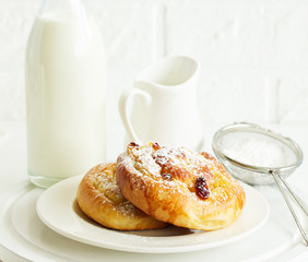 Bun with raisins and cream. Selective focus