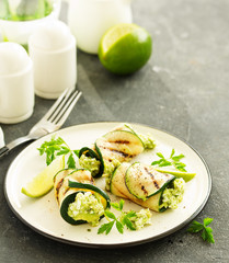 Zucchini rolls stuffed with cottage cheese and avocado. Snack. Selective focus.