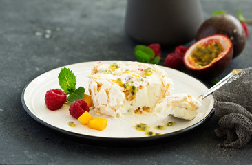 Meringue roulade with raspberries and passion fruit. Pavlova. Dessert. Selective focus