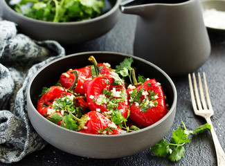 Baked bell peppers salad with herbs and garlic. Eastern dish.